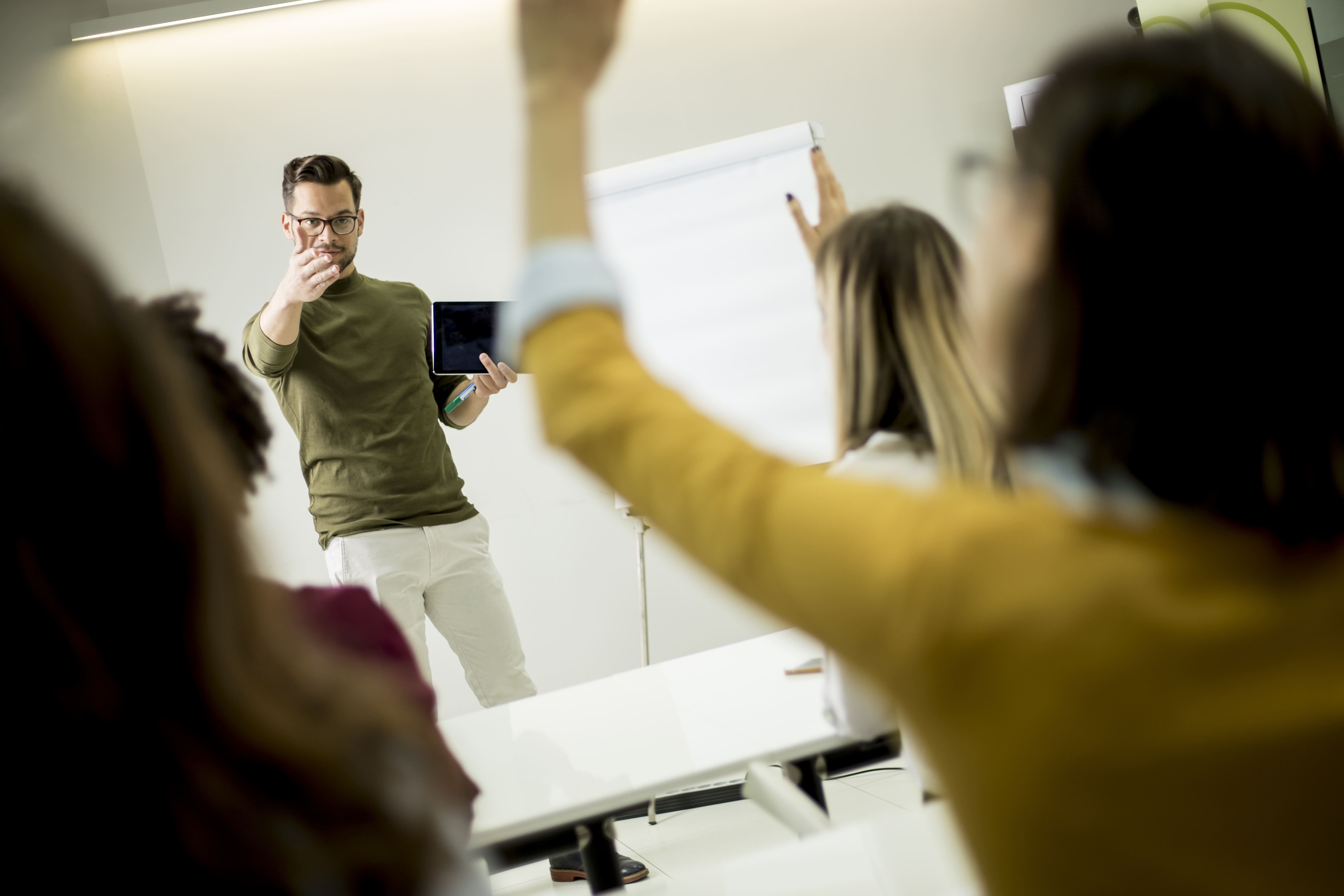 Students rising hands to answer the question during the workshop training